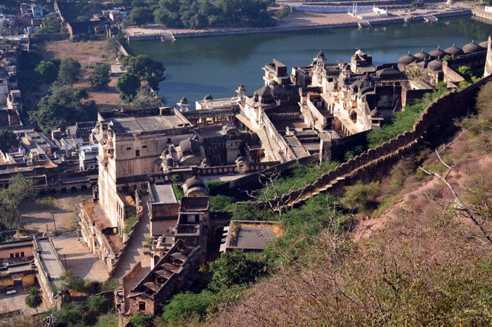 Aerial view of the historic Taragarh Fort nestled along the rugged Nagpahari hills in Ajmer, overlooking a lake and the city below